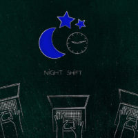 group of laptop users working in team and night shift icon with moon and clock above them